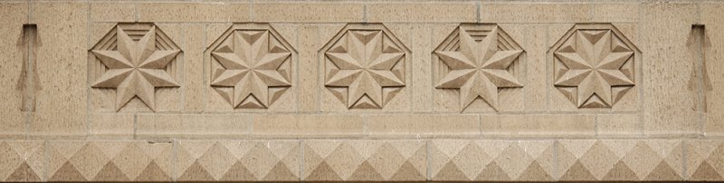 Stone star carvings detail on BW building
