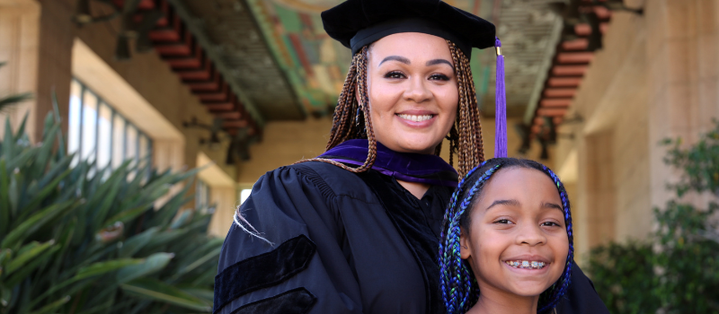 Southwestern student in graduation regalia with her daughter