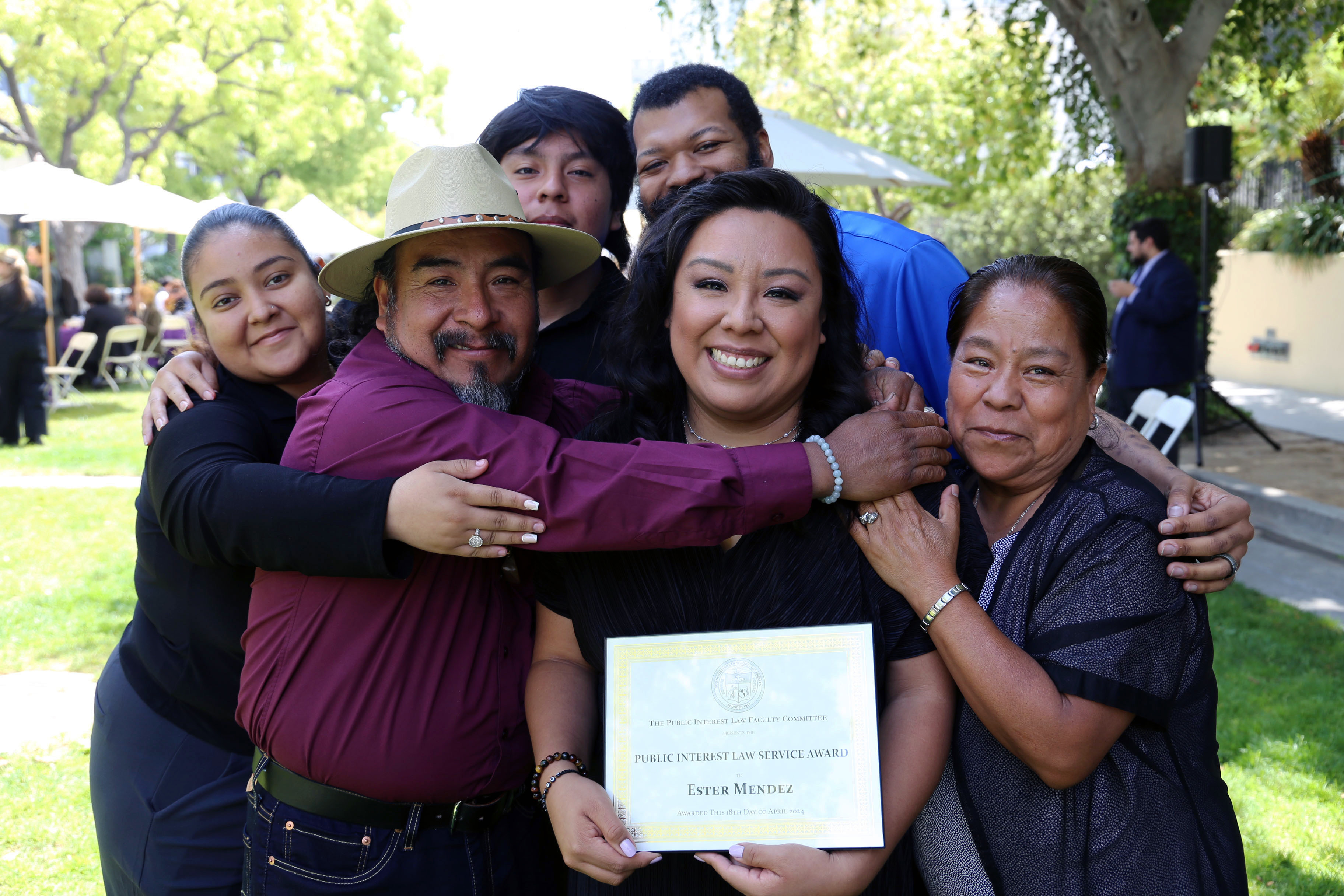 Ester Mendez receiving her Public Service Award with her family at the Public Service Program luncheon