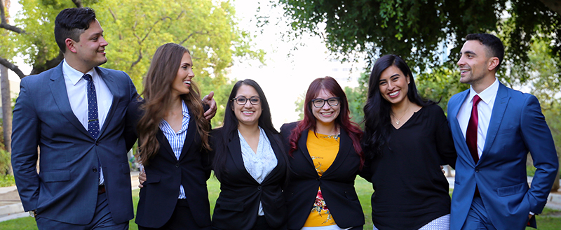 Image - Group of Southwestern Students walking across promenade with arms around each others shoulders