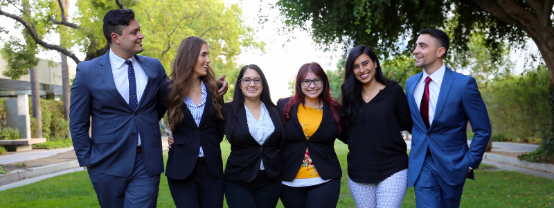 Image - Group of Southwestern Students walking across promenade with arms around each others shoulders