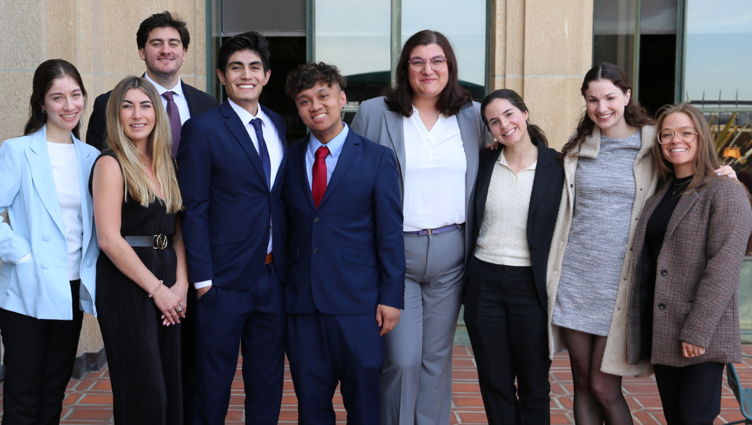 Group of students in business professional wear smiling at camera