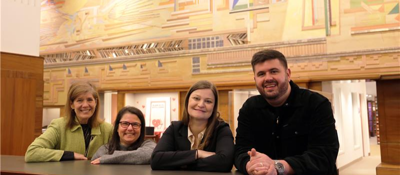 Online J.D. student peer mentors in the library in a row.