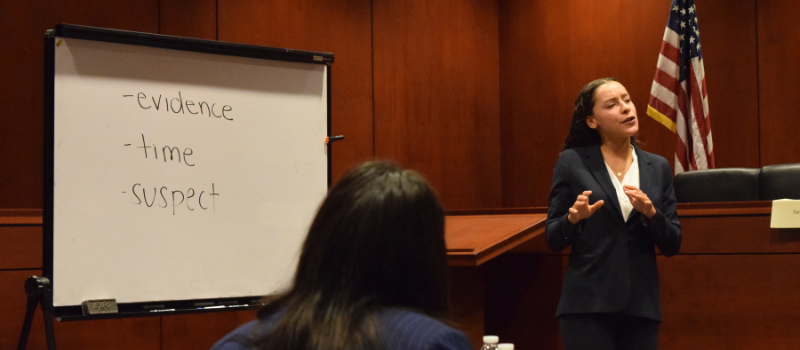 SCALE TA in courtroom in front of whiteboard speaking