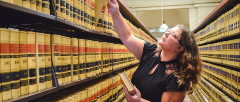 Stephanie Anderson choosing a book in library