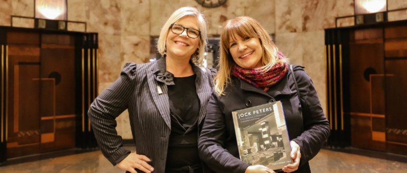 Two visitors at the Bullocks Wilshire salon with book