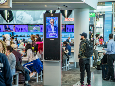 LAX airport with EVision screen showing Southwestern Student 