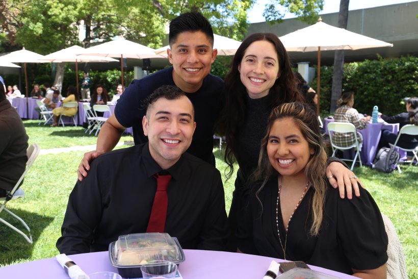 Four smiling students on Southwestern's promenade, celebrating an award ceremony