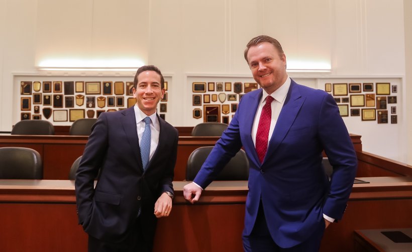 Robert Glassman and Dan Kramer standing by jury box in Southwestern's Julian Dixon Courtroom