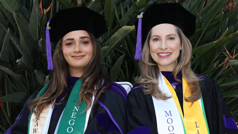 Hailey Roknipour and Piper Hinson in commencement regalia