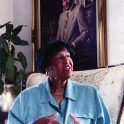 Lorraine Bradley in front of an official mayoral portrait of her father