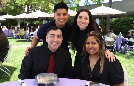 Four smiling students on Southwestern's promenade, celebrating an award ceremony 