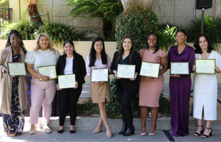 Angel Ajala, Fabiola Martinez, Jovana Morales, Vivian Kim, Cristina Terrazas, Markisha Roches, Tatiana Owens, and Eleni Rodriguez standing in a line holding their award certificates