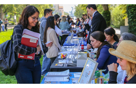 Students meeting representatives at booths at the Public Interest Public Service Employer Fair 