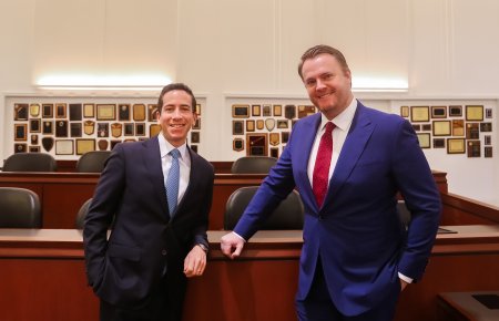 Robert Glassman and Dan Kramer standing by jury box in Southwestern's Julian Dixon Courtroom