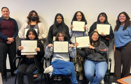 New Village Girls Academy Class with their certificates at their culminating class at Southwestern. 