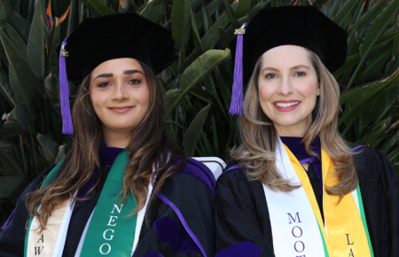 Hailey Roknipour and Piper Hinson in commencement regalia