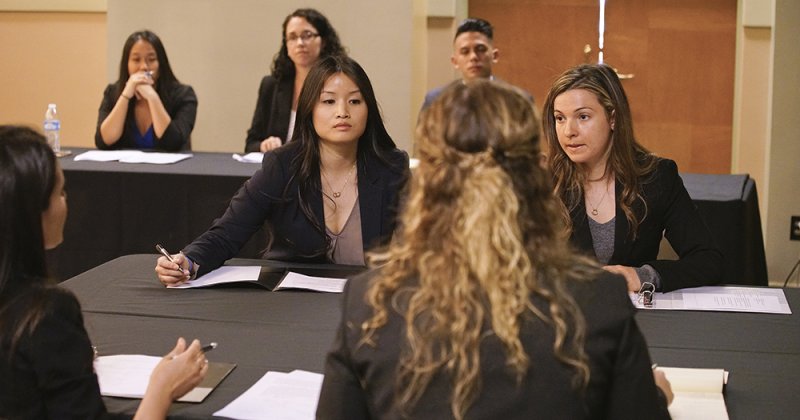 Negotiation competition with Professor Knolton in background